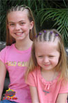 AnnaLia and Jolie posing after getting their hair braided.
