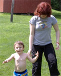 Logan and Caitlin running under a sprinkler, 2006